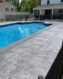 Stamped Concrete Pool Patio by Coastal Creations, LLC.